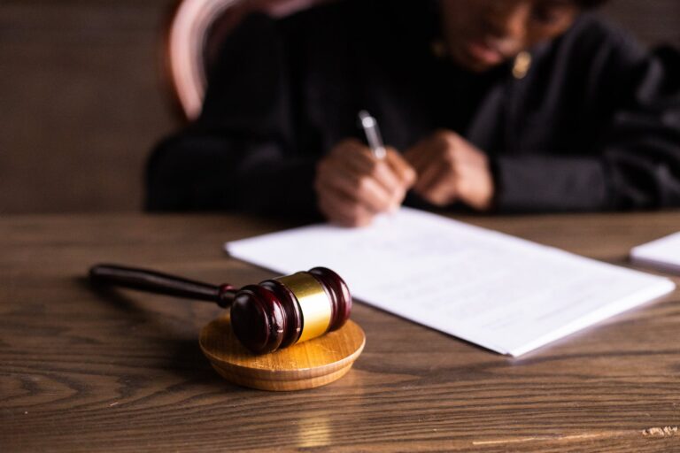 judge signing on the papers for NY Court Cameras