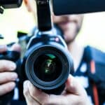 A person holding canon camera for NY court