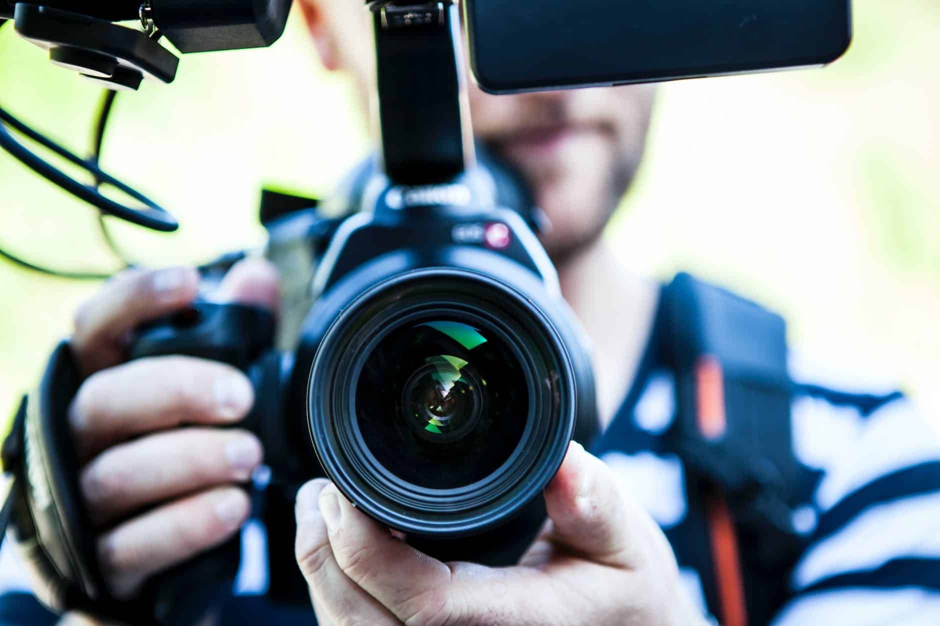 A person holding canon camera for NY court