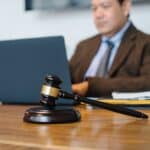 judge working on laptop with cameras in NY Courts