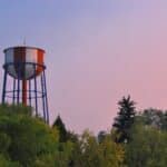 idaho falls water tower near green trees under evening sky